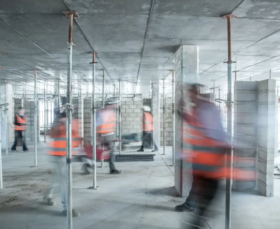 six-blurred-construction-workers-on-the-go-in-busy-2022-03-07-23-57-53-utc